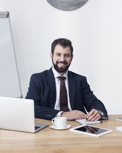 portrait-of-smiling-businessman-looking-at-camera-team