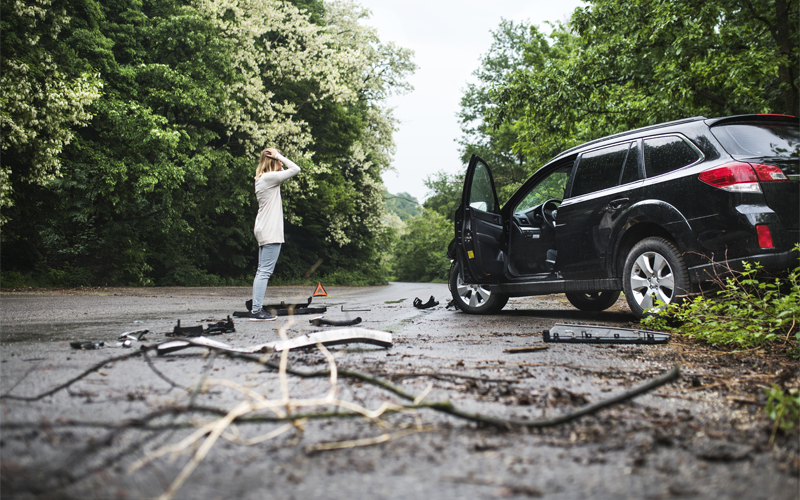 young-woman-standing-by-the-damaged-car